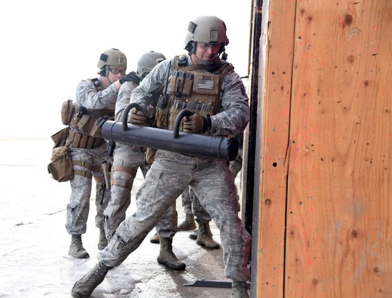 Staff Sgt. Jarrid Wrege, 341st Security Forces Group Tactical Response Force member, uses a ram to breach into a room during a training exercise at Malmstrom Air Force Base, Mont., Nov. 18. To begin training as a breacher, students attend a two-week long course which teaches them how to properly utilize tools and courses which demonstrate how to safely build and detonate explosives used for facility entry. (U.S. Air Force photo/Airman 1st Class Joshua Smoot)
