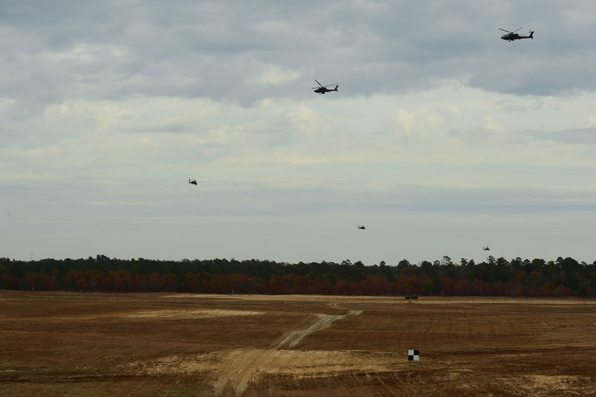 AH-64 Apaches assigned to the 1-130 Attack Recon Battalion, North Carolina Army National Guard, based at the Raleigh-Durham International Airport, train at Poinsett Electronic Combat Range, Sumter, S.C., Nov. 13, 2014. Ten Apaches flew to Poinsett to train on the range. In addition to training with electronic warfare, the pilots also had smoky SAMS (surface-to-air missiles) launched in their vicinity. (U.S. Air Force photo by Airman 1st Class Diana M. Cossaboom/Released)