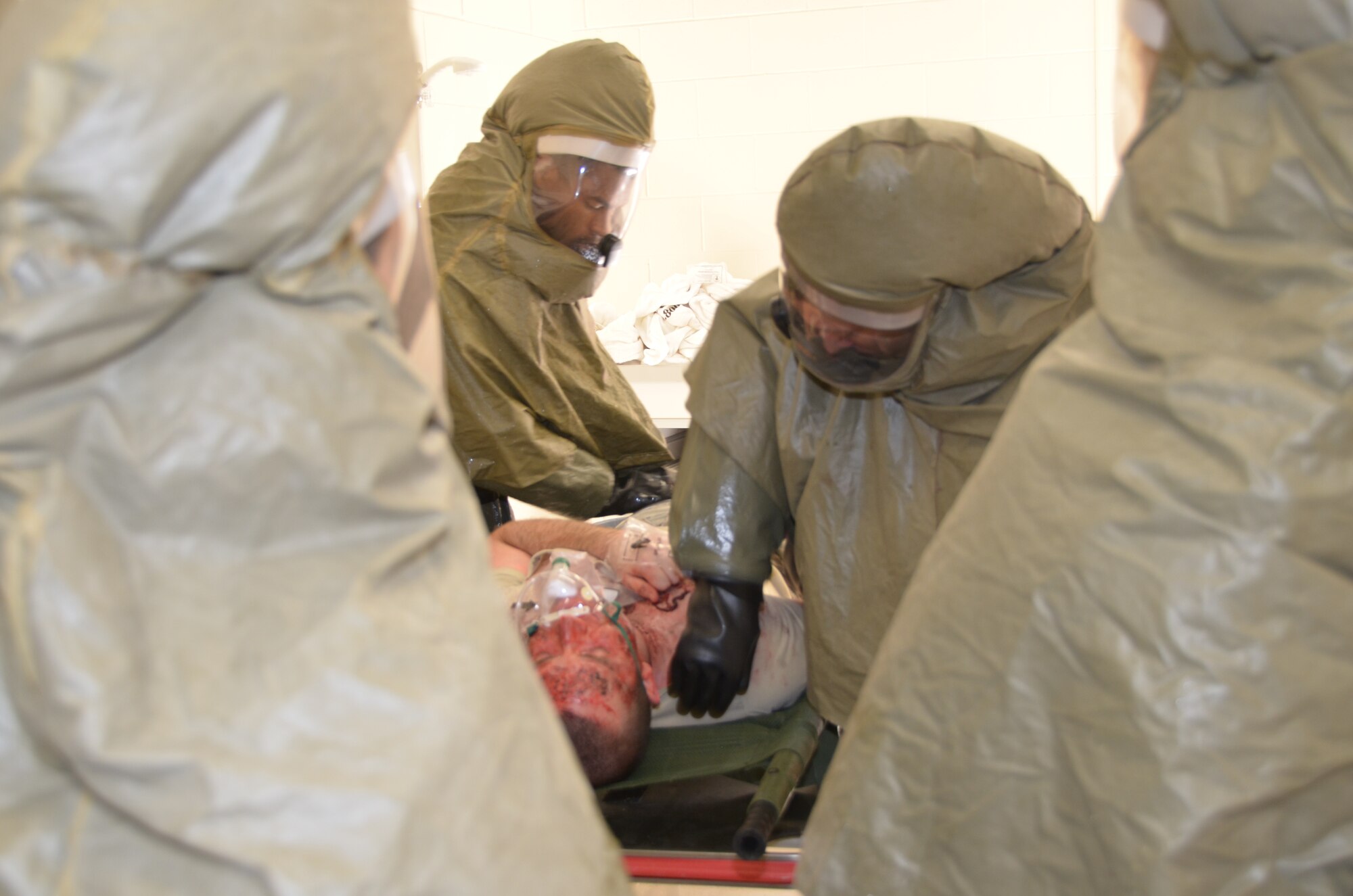 The Keesler Medical Center decontamination team processes “victim” Senior Airman Willie Moore, 81st Logistics Readiness Squadron, during the Nov. 5 major accident response exercise.  The exercise scenario involved an Airman accidentally hitting a chemical drum with forklift tines while unloading it from a truck.  A drum ruptureed and others were pushed off the truck.  Several other Airmen assisting with the unloading are splashed with the brown oily liquid and immediately start to experience skin and eye burns.  Additional airmen on the loading dock and in the warehouse start coughing and experiencing shortness of breath.  The Airmen that are splashed with the chemical immediately get in a vehicle and head to the Emergency Room.  Another airman in the warehouse calls 911 and reports the incident.  “Victims” were decontaminated before being triaged and taken into the medical center for care.