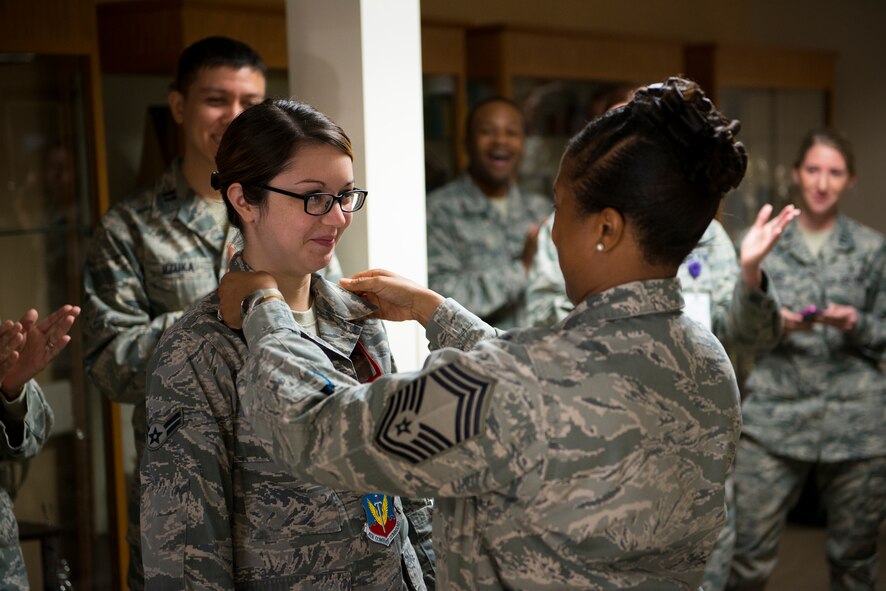 U.S. Air Force Chief Master Sgt. Bionca Lindsey, right, Air Combat Command Surgeon General Office medical enlisted force chief, presents the ACC Real Pro award to Airman 1st Class Kaitlynn Curry, 23d Medical Operations Squadron, Nov. 19, 2014, at Moody Air Force Base, Ga. The Real Pro award is given to superior performers in Medical Groups throughout ACC. (U.S. Air Force photo by Airman 1st Class Ryan Callaghan/Released)