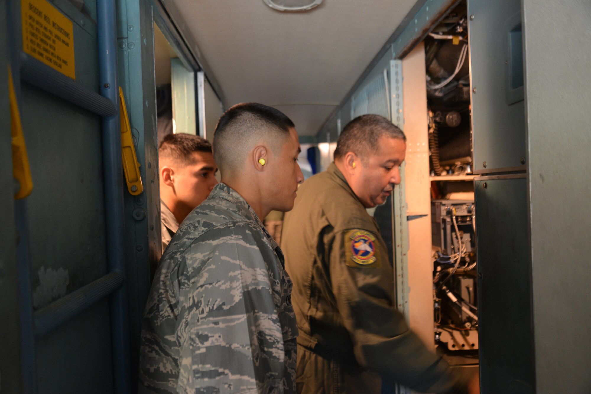 Flight Engineer Senior Master Sgt. Robert Reyes with the 68th Airlift Squadron goes over the C-5A Galaxy’s avionics bay with Capt. Robert Orallo, (left forefront) 433rd Logistic Readiness Squadron, flight commander, Vehicle Management Flight and Staff Sgt. Eric Martinez, a knowledge operations management specialist. Thirteen outstanding Airmen from Joint Base San Antonio-Lackland, Texas received an incentive flight, Nov 1, 2014 aboard a C-5A Galaxy aircraft sponsored by the 433rd Airlift Wing. This is the first incentive flight in a long while given by the “Alamo Wing.” The incentive flight was sponsored by the Operations Group, and flown by courtesy of pilots from the 68th Airlift Squadron.  (U.S. Air Force Photo/Minnie Jones)
