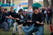 Airmen from the 23d Maintenance Group compete in a tug-of-war during Weapons Fest Nov. 15, 2014, at Grassy Pond in Lake Park, Ga. The contest ended after the rope was torn in half during a rivalry match between the 74th and 75th Aircraft Maintenance Units. (U.S. Air Force photo by Airman 1st Class Ryan Callaghan/Released)