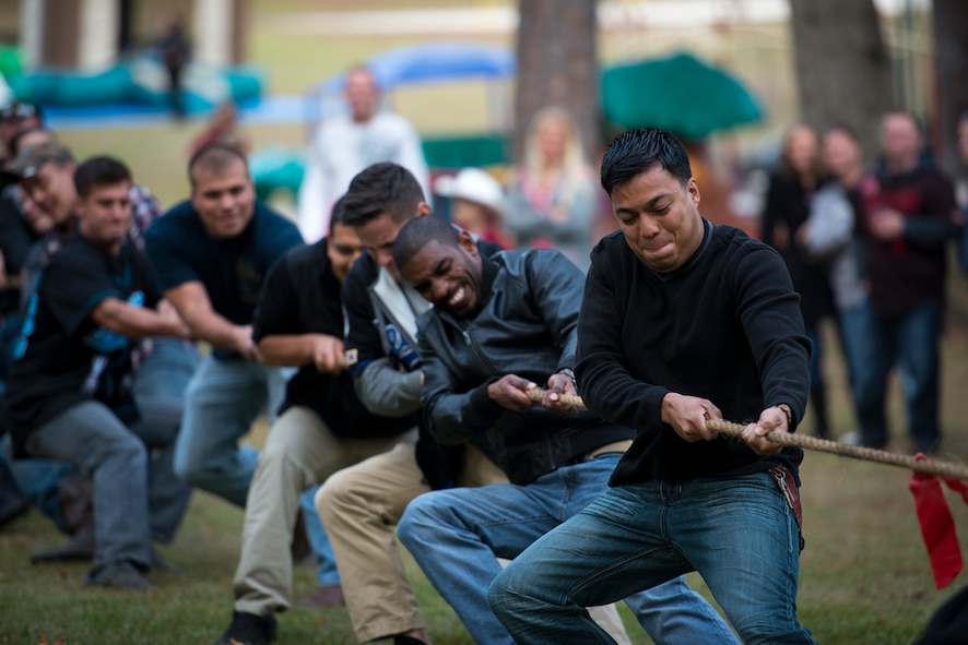 Airmen from the 23d Maintenance Group compete in a tug-of-war during Weapons Fest Nov. 15, 2014, at Grassy Pond in Lake Park, Ga. The contest ended after the rope was torn in half during a rivalry match between the 74th and 75th Aircraft Maintenance Units. (U.S. Air Force photo by Airman 1st Class Ryan Callaghan/Released)