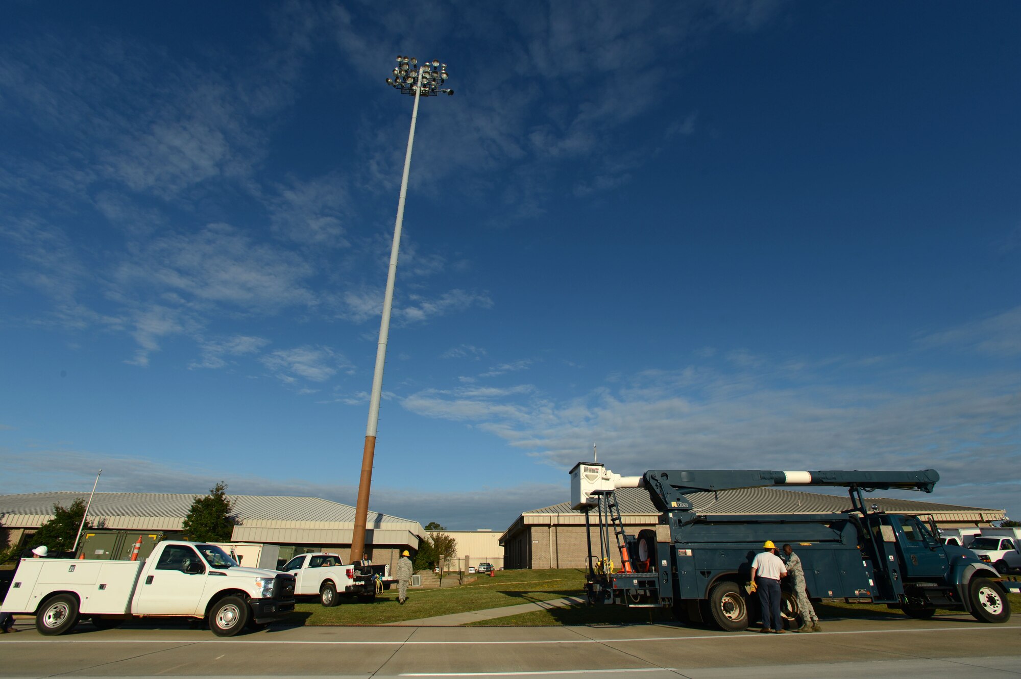 Electrical systems Airmen assigned to the 20th Civil Engineer Squadron prepare to perform maintenance on a ramp light along the flightline at Shaw Air Force Base, S.C., Oct. 16, 2014. A team of at least five Airmen are needed to perform maintenance on the lights, two on the ramp tower and three on the ground. (U.S. Air Force photo by Airman 1st Class Jensen Stidham/Released)
