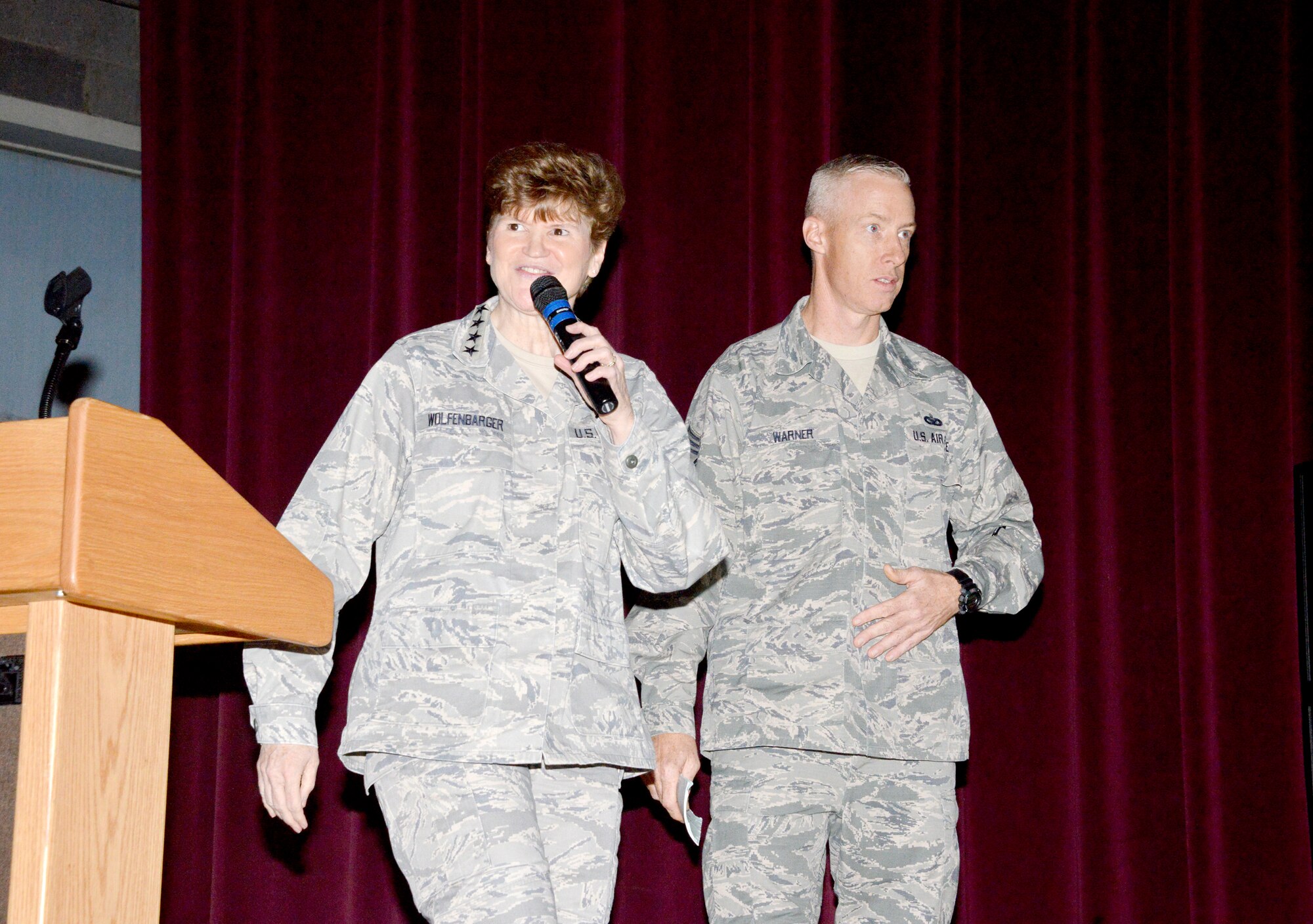 Gen. Janet Wolfenbarger, commander of Air Force Materiel Command, and Chief Master Sgt. Michael Warner, AFMC command chief, speak at a commander's call at the Base Theater Nov. 17. Wolfenbarger discussed successes and the challenges that lie ahead. During the general's trip to Kirtland, she met with base leadership and visited units, including the Air Force Nuclear Weapons Center and Air Force Research Laboratory. (Photo by Dennis Carlson)