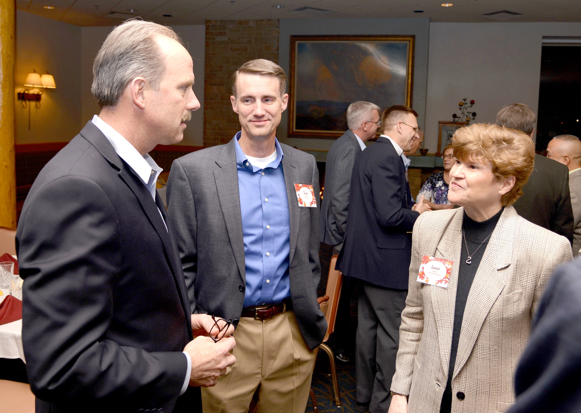 Gen. Janet Wolfenbarger, commander of Air Force Materiel Command, and Col. Tom Miller, 377th Air Base Wing commander, speak with Albuquerque Mayor Richard Barry at a dinner gathering with community leaders at the Mountain View Club Nov. 17. During the general's trip to Kirtland, Wolfenbarger met with base leadership and visited units, including the Air Force Nuclear Weapons Center and Air Force Research Laboratory. (Photo by Todd Berenger)
