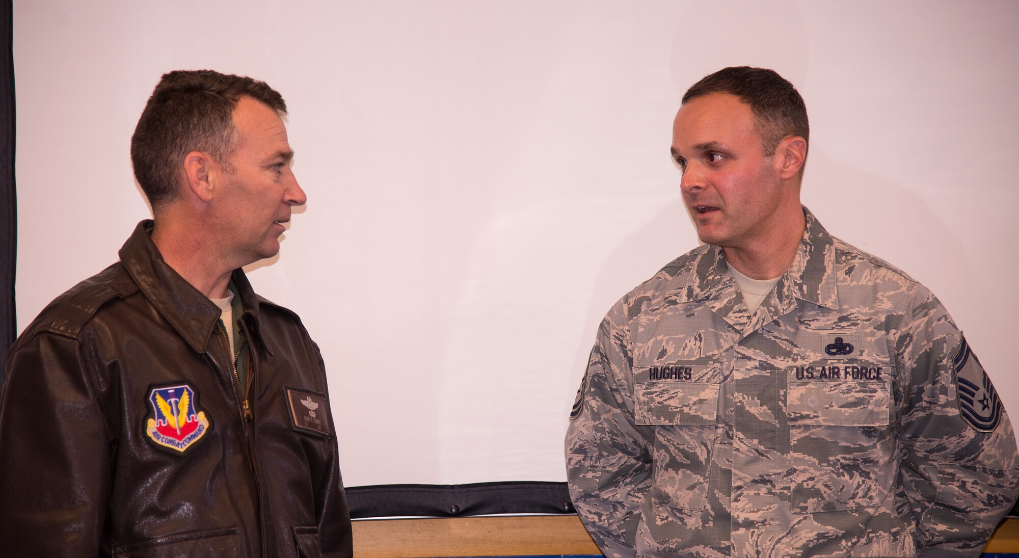U.S. Air Force Senior Master Sgt. Jason Hughes, 74th Aircraft Maintenance Unit assistant superintendent, speaks with Col. Chad Franks, 23d Wing commander, after finding out he was selected to promote to the rank of chief master sergeant. Base leadership and a group of chief master sergeants went to each selectee’s duty section to tell them the news. (U.S. Air Force photo by Senior Airman Sandra Marrero/Released)
