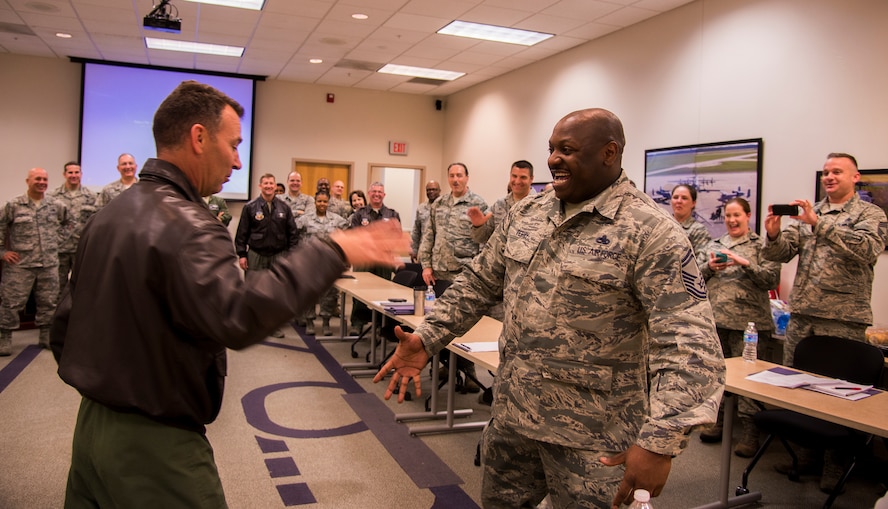 U.S. Air Force Col. Chad Franks, 23d Wing commander, shakes hands with Senior Master Sergeant Keith Terry, 23d Component Maintenance Squadron superintendent Nov. 19, 2014, at Moody Air Force Base, Ga. Terry was one of six Moody members selected for promotion to chief master sergeant. (U.S. Air Force photo by Senior Airman Sandra Marrero/Released)
