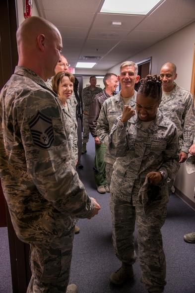 U.S. Air Force Chief Master Sgt. Bionca Lindsey, Air Combat Command Surgeon General Office medical enlisted force chief, congratulates Senior Master Sgt. Stephen Hart, 23d Medical Operations Squadron superintendent, on being selected for promotion to the rank of chief master sergeant at Moody Air Force Base, Ga., Nov. 19, 2014. Upon being notified, Hart joined a group of chiefs to tell the remaining senior master sergeants of their selection for promotion. (U.S. Air Force photo by Senior Airman Sandra Marrero/Released) 

