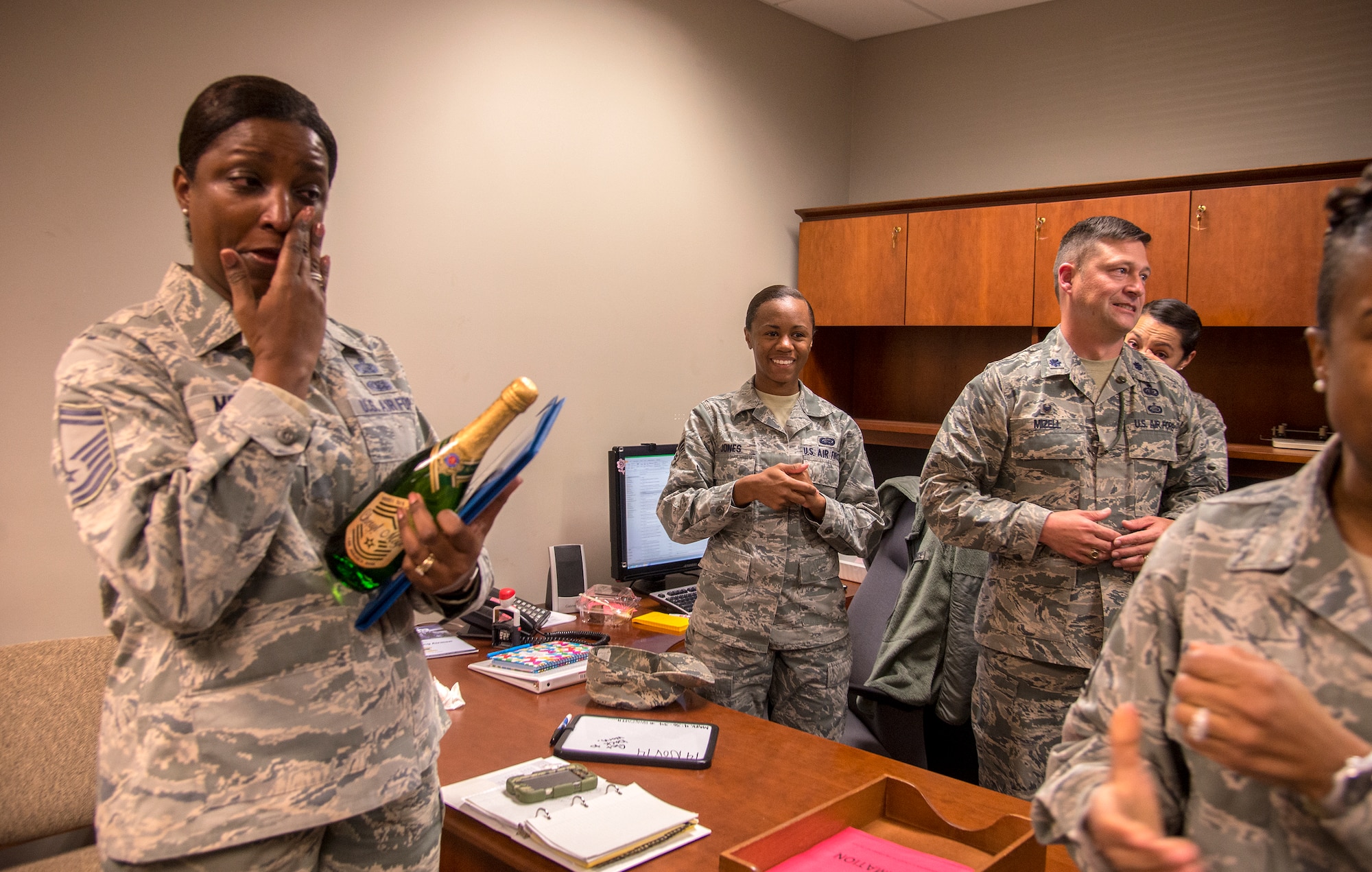 U. S. Air Force Senior Master Sgt. Cheryl Moye, 23d Force Support Squadron manpower and personnel superintendent, wipes away tears Nov. 19, 2014, at Moody Air Force Base Ga. A group of chiefs and base leadership members gave her the news she was selected to promote to chief master sergeant. (U.S. Air Force photo by Senior Airman Sandra Marrero/(Released)
