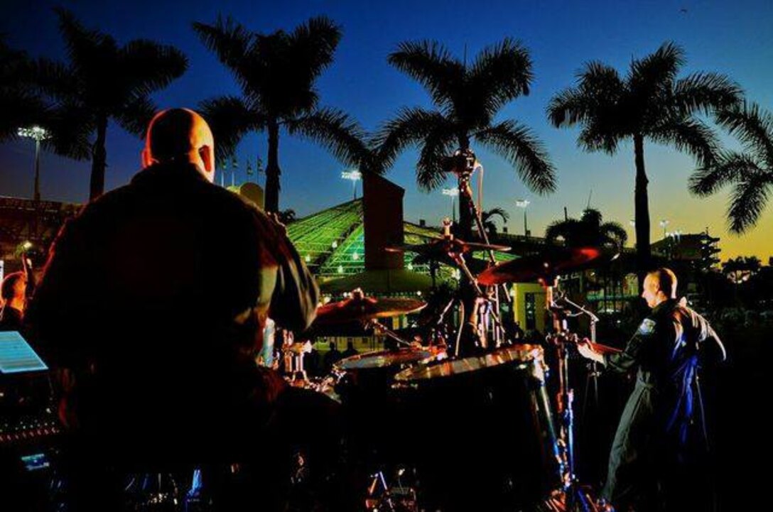 Max Impact entertains NASCAR fans at the Homestead-Miami Speedway in Florida.  Technical Sergeant Robert Smith, shown here, leads the group from the drum set and Senior Master Sergeant Matt Ascione takes a guitar solo. (U.S. Air Force Photo by Senior Master Sgt. Bob Kamholz)