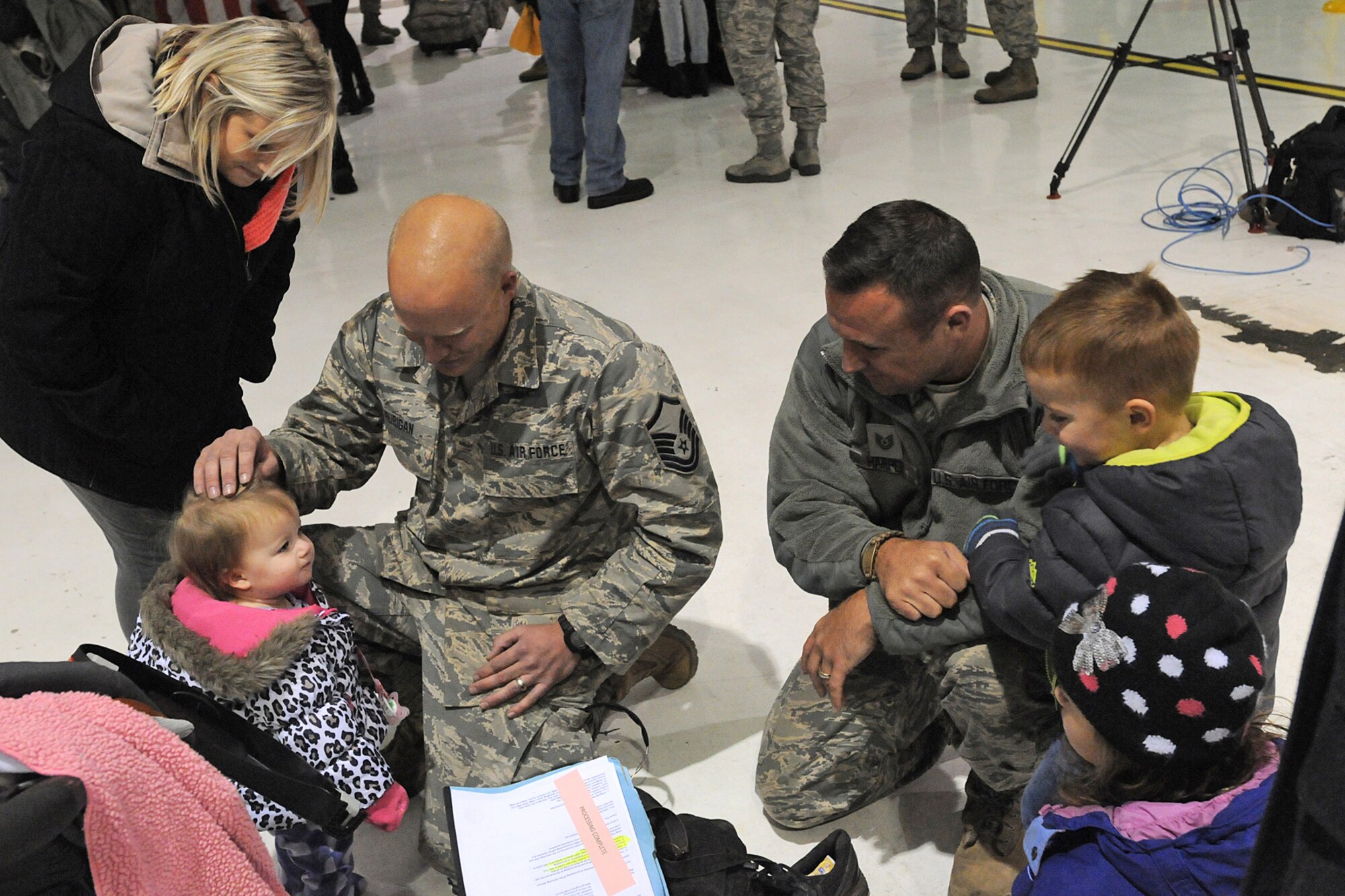 Master Sgt. Matthew Hourigan (left) and Tech Sgt. Jacob Harper greet their children in Louisville, Ky., after the Airmen returned from a deployment, Nov. 19, 2014. The Airmen with the 123rd Contingency Response Group deployed to West Africa in support of Operation United Assistance, the international effort to fight Ebola. (U.S. Army National Guard photo by Staff Sgt. Scott Raymond)
