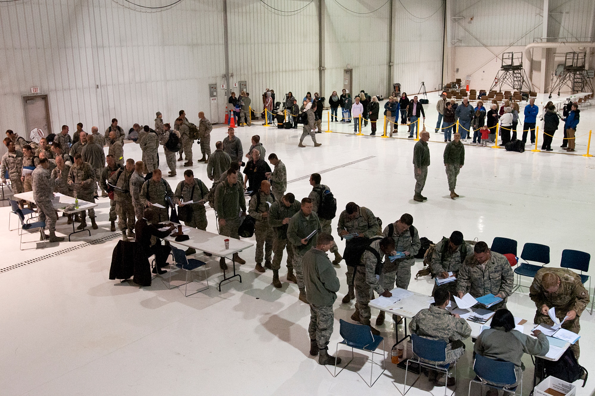 Airmen with the 123rd Contingency Response Group file through in-processing after landing at the Kentucky National Guard Air Base in Louisville, Ky., Nov. 19, 2014. After serving in an Ebola-free area of West Africa, the Airmen were not required to be quarantined or self-monitored for 21 days. (U.S. Army National Guard photo by Staff Sgt. Scott Raymond)
