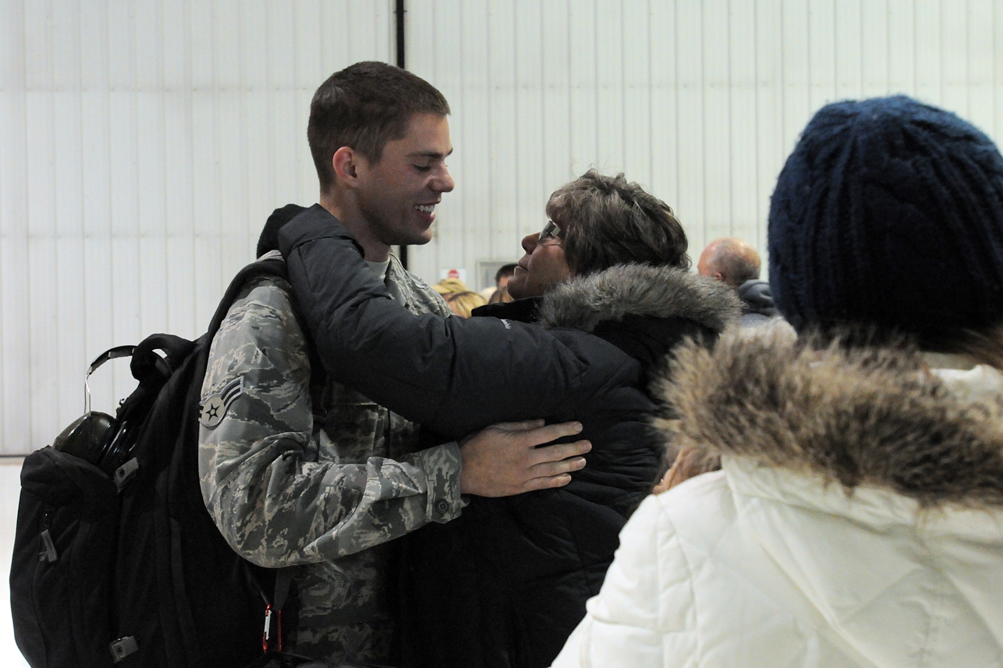 An Airman with the 123rd Contingency Response Group greets family members in Louisville, Ky., after returning home for a deployment to West Africa Nov. 19, 2014. The flight was the first of several bringing the unit home from overseas. (U.S. Army National Guard photo by Staff Sgt. Scott Raymond)
