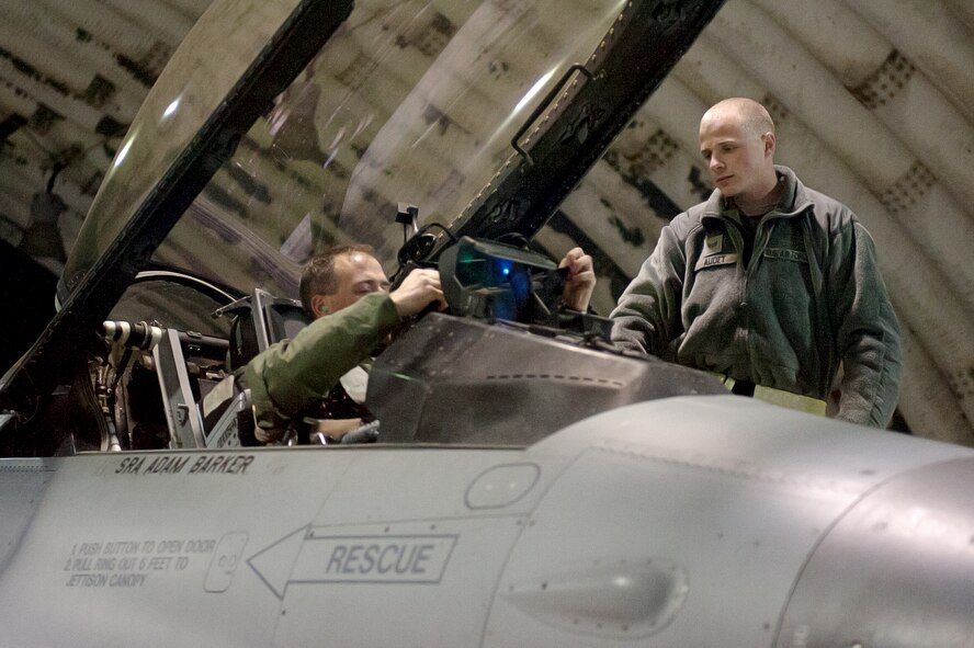 Senior Airman Benjamin Audet, 8th Aircraft Maintenance Squadron crew chief, prepares a pilot to launch during Exercise Max Thunder 15-1 Nov. 18, 2014, Kunsan Air Base, Republic of Korea. U.S. Air Force, Army, Marine Corps and Navy personnel and aircraft are training alongside ROK air forces in the semi-annual, bilateral training event, which is the largest flying exercise held on the Korean Peninsula. (U.S. Air Force photo by Senior Airman Divine Cox/Released)