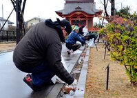 U.S. Air Force and Japan Air Self-Defense Force personnel clean leaves out of gutters at a park in Komastu, Japan, Nov. 15, 2014. U.S. servicemembers from the 212th Rescue Squadron, 33rd RQS, and 35th Fighter Wing teamed up with members from the Japan Air Self-Defense Force and the Kinki-Chubu Defense Bureau in an effort to clean up a local park. The 35th FW from Misawa Air Base, Japan, was at Komatsu Air Base for an Aviation Training Relocation Program. The 33rd and 212th Rescue Squadrons were at Komatsu for exercise Keen Sword. The bilateral training conducted during exercise Keen Sword and in the ATR was to practice and evaluate the coordination procedures and interoperability elements required to effectively and mutually respond to the defense of Japan, or to a regional crisis. (U.S. Air Force photo by 2nd Lt. Erik Anthony/Released)