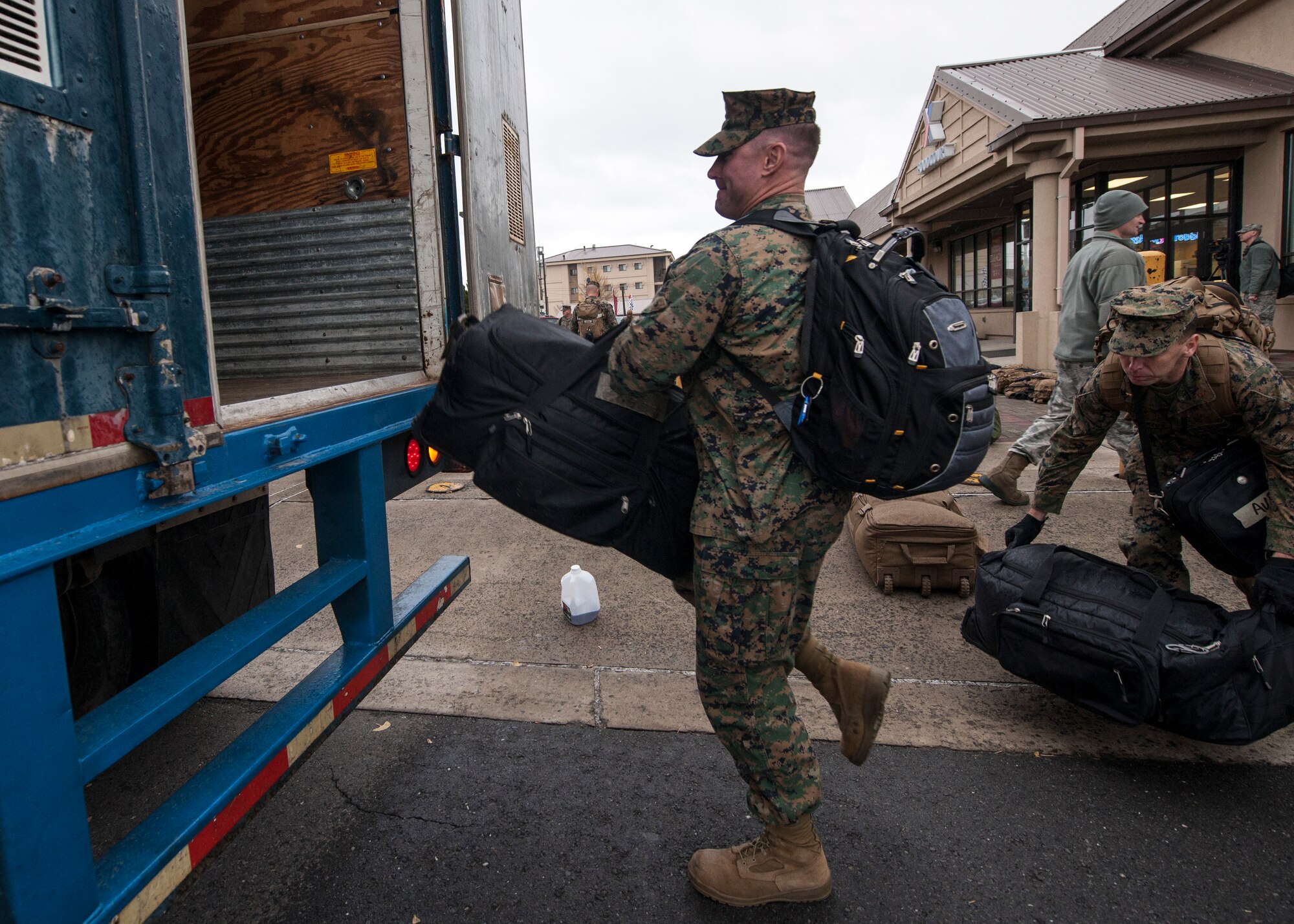 U.S. Marines load their personal belongings onto a bus to be shipped to lodging after arriving at Kunsan Air Base, Republic of Korea, Nov. 13, 014. More than 1,000 personnel from various ROK air force units, the U.S. Navy, Marine Corps, Army and Air Force participated in Max Thunder 14-2, the largest biannual joint training exercise on the Korean Peninsula. (U.S. Air Force photo by Senior Airman Katrina Heikkinen/Released)