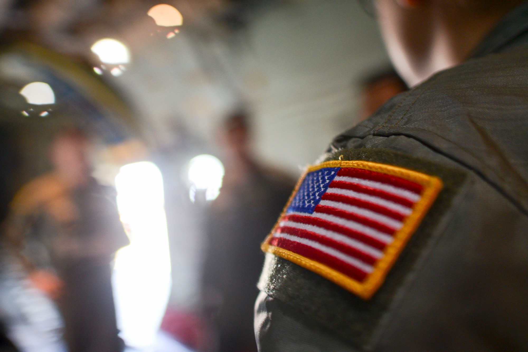 The U.S. flag sits on the shoulder of a loadmaster during Exercise Max Thunder, Nov. 19, 2014. The 36th Airlift Squadron practiced combat maneuvers and low-altitude flying alongside Republic of Korea counterparts. (U.S. Air Force photo by Staff Sgt. Cody H. Ramirez/Released)