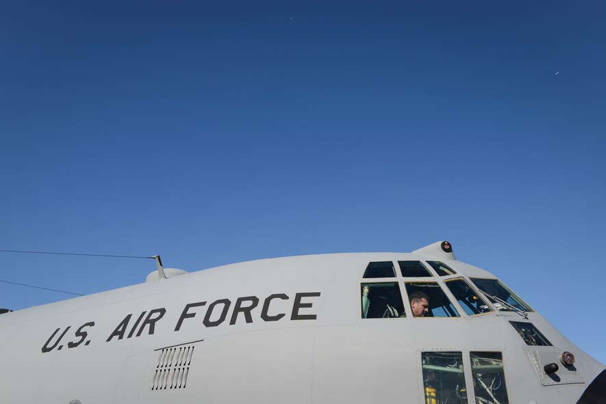 Lt. Col. Eric Gualin, 374th Airlift Wing C-130 pilot, conducts preflight checks at Yokota Air Base, Japan, before taking off during Exercise Max Thunder Nov. 19, 2014. The 36th Airlift Squadron practiced combat mobility with tactical airlift procedures alongside Republic of Korea counterparts. (U.S. Air Force photo by Staff Sgt. Cody H. Ramirez/Released)