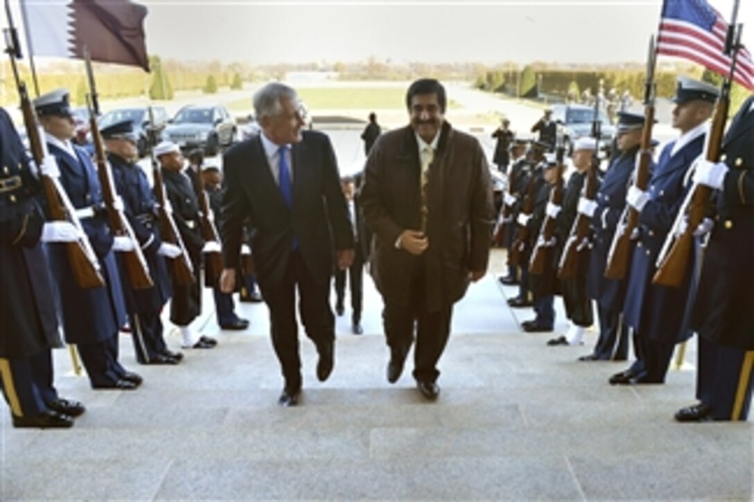 U.S. Defense Secretary Chuck Hagel escorts Qatar Minister of State for Defense Affairs Maj. Gen. Hamad bin Ali al-Atiyah to the Pentagon, Nov. 21, 2014. The two defense leaders met to discuss issues of mutual importance.