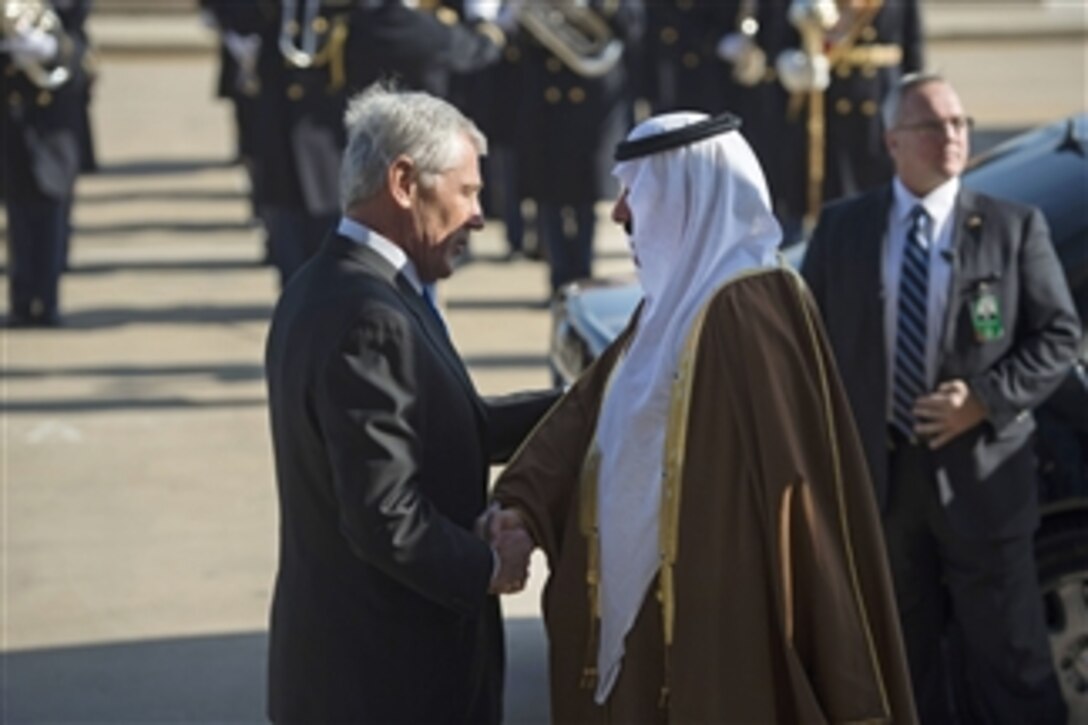 U.S. Defense Secretary Chuck Hagel, left, greets Saudi National Guard Minister Prince Mitib bin Abdullah bin Abdul Aziz Al Saud as he arrives at the Pentagon to discuss matters of mutual importance, Nov. 21, 2014.