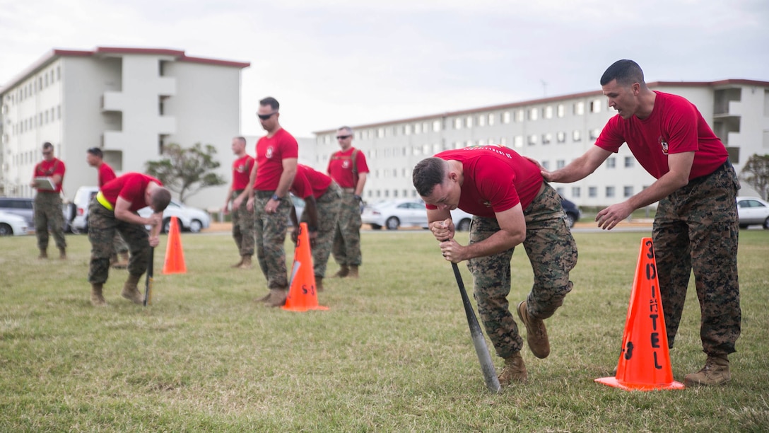 Marines compete in a dizzy izzy relay race Nov. 14 on Camp Hansen’s Parade Field during a 3rd Intelligence Battalion field meet. The event brought Marines together for some friendly competition, increasing unit cohesion and camaraderie. The Marines are with 3rd Intel. Bn., III Marine Expeditionary Force Headquarters Group, III MEF. 