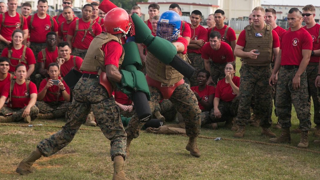 Marines cheer on their teammates during a pugil stick bout Nov. 14 on Camp Hansen’s Parade Field during a 3rd Intelligence Battalion field meet. The pugil stick competition served as the main event of the field meet, which drew a lot of excitement from a loud crowd. The Marines are with 3rd Intel. Bn., III Marine Expeditionary Force Headquarters Group, III MEF. 