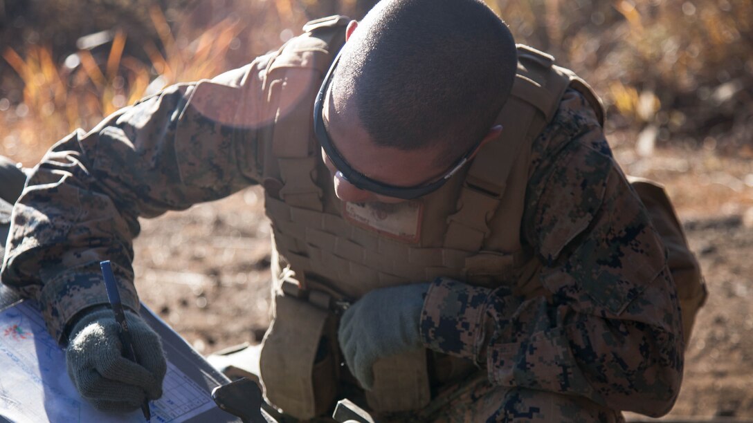 Cpl. Thomas G. Martinez prepares a howitzer range card before artillery fire commences Nov. 4 at the North Fuji Maneuver Area during Artillery Relocation Training Program 14-3. ARTP is a regularly scheduled training event that increases combat readiness of U.S. Marine forces, and supports the U.S.-Japan Treaty of Mutual Cooperation and Security. Martinez is from Los Angeles, California, and is a field artillery cannoneer with Battery B, 1st Battalion, 12th Marine Regiment based out of Kaneohe Bay, Hawaii, currently assigned to 3rd Bn., 12th Marines, 3rd Marine Division, III Marine Expeditionary Force under the Unit Deployment Program. 