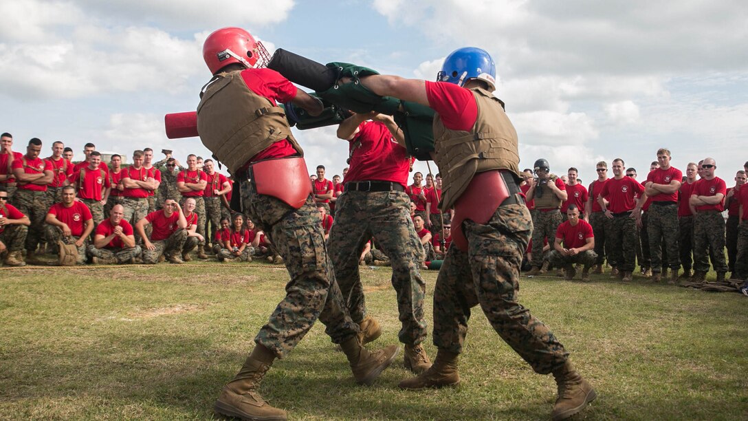 Marines cheer on their teammates during a pugil stick bout Nov. 14 on Camp Hansen’s Parade Field during a 3rd Intelligence Battalion field meet. The pugil stick competition served as the main event of the field meet, which drew a lot of excitement from a loud crowd. The Marines are with 3rd Intel. Bn., III Marine Expeditionary Force Headquarters Group, III MEF. 