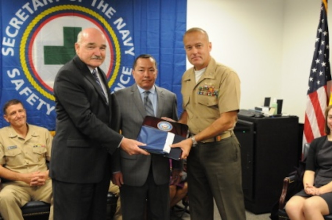 (From left to right) Mr. Dennis McGinn, Assistant Secretary of the Navy for energy, installations and environment, presents the Secretary of the Navy’s Safety Excellence Award to Ray Aguilar, base safety officer on MCLB Barstow, and Col. Michael L. Scalise, commanding officer of MCLB Barstow, Oct. 20.


