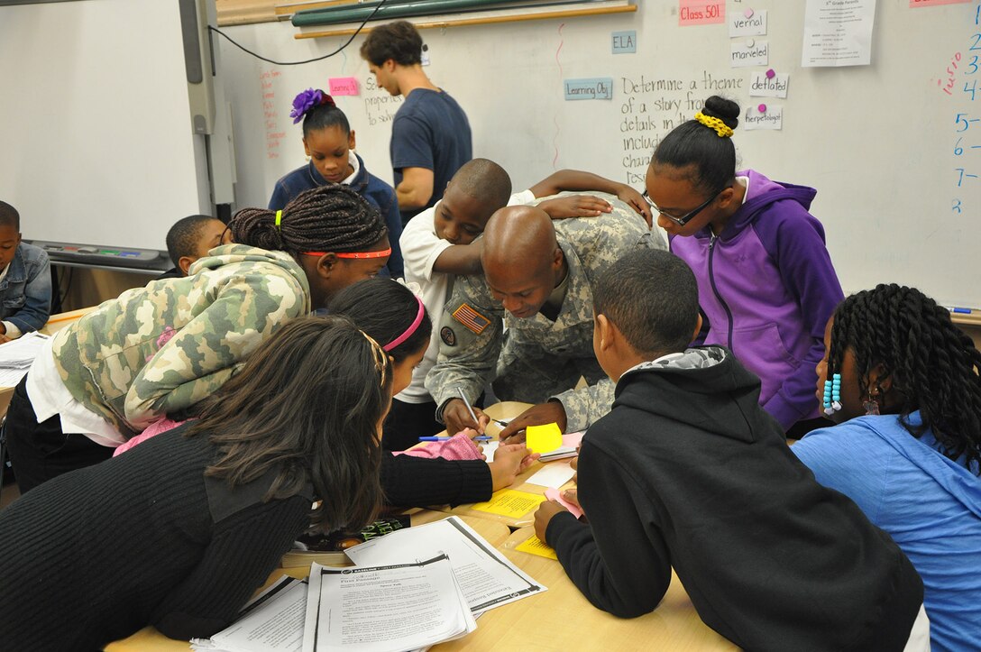 Lt. Col. John A. Knight, deputy commander, U.S. Army Corps of Engineers, New York District giving students his autograph after providing them some of his life lessons. 