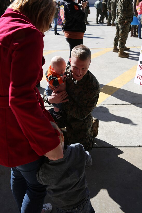 Cpl. Tyler J. Bohnenkamp reunites with his family at Marine Corps Air Station Cherry Point, N.C., Nov. 19, 2014. Bohnenkamp was deployed more than six months supporting Marine Medium Tiltrotor Squadron 262, (Reinforced), the Aviation Combat Element of the 31st Marine Expeditionary Unit during its patrol of the Asia-Pacific region. Bohnenkamp is a consolidated automated support system technician with Marine Attack Squadron 542 and is native to Sioux Center, Iowa.