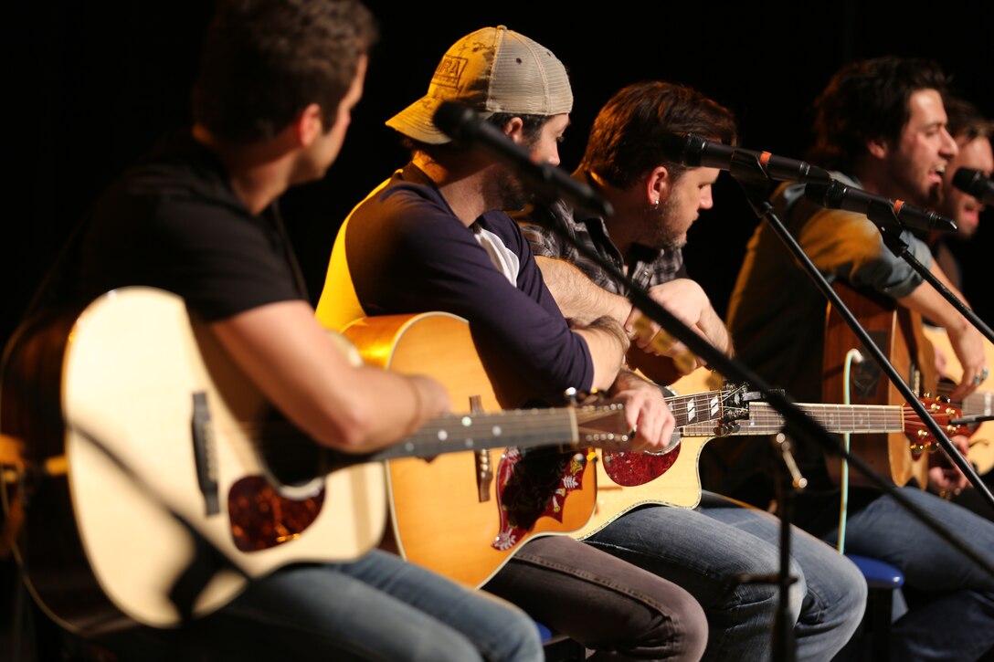 Country music artists a song by Austin Webb, right, during the 6th Annual Guitar Pull at Marine Corps Air Station Cherry Point, N.C., Nov. 19, 2014. The artists performed for more than 1,800 Marines, Sailors and community members during the sold out concert. Webb is a country music artist and native of Williamston, S.C.