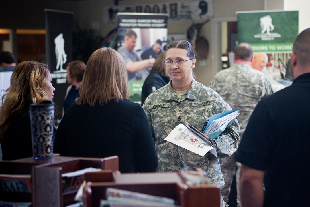 Staff Sgt. Shirley Clingan, a soldier at Fort Campbell's Warrior Transition Battalion, discusses internship opportunities with Defense Finance and Accounting Service during Operation Warfighter's quarterly Career Fair at the Soldier and Family Assistance Center Nov. 19, 2014.