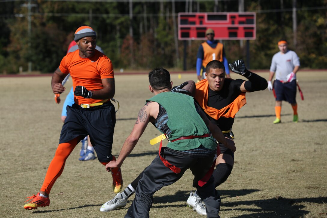 Marines and Sailors with 2nd Marine Aircraft wing and Marine Corps Air Station Cherry Point play flag football during the 2nd annual Turkey Bowl flag football tournament at Marine Corps Air Station Cherry Point, N.C., Nov. 21, 2014. The tournament is conducted to raise camaraderie throughout the squadrons at Cherry Point and to celebrate the Thanksgiving season.  This year 150 Marines and Sailors participated in the tournament. 