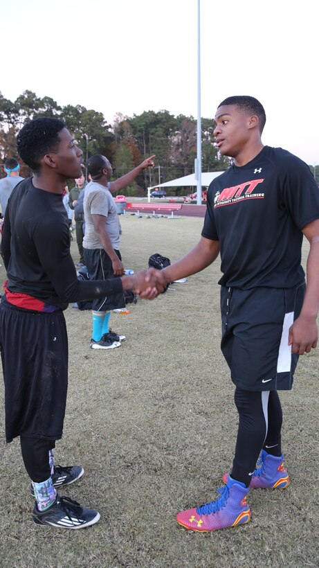 Cameron King, (left), and Adariakeem Taylor shake hands after competing in the 2nd Annual Turkey Bowl flag football tournament hosted by Marine Wing Headquarters Squadron 2 at Marine Corps Air Station Cherry Point, N.C., Nov. 21, 2014. King is the captain of Headquarters and Headquarters Squadron team Benchwarmers and Taylor is the captain of Unmanned Aerial Vehicle Squadron 2 team Hashtag Thuggaz. Both teams went head to head in the final round of the Turkey Bowl. The Turkey Bowl was conducted to raise camaraderie throughout the squadrons of 2nd Marine Aircraft Wing. 