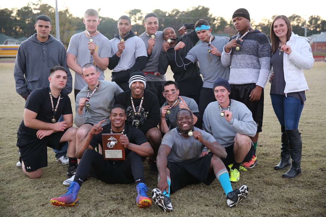 Team Hashtag Thuggaz pose for a photo after winning the 2nd Annual Turkey Bowl flag football tournament at Marine Corps Air Station Cherry Point, N.C., Nov. 21, 2014. The team emerged victorious over 10 other teams to earn flag football glory. The tournament was hosted by Marine Wing Headquarters Squadron 2. This year 11 teams competed in the double-elimination tourney, where 150 Marines and Sailors supported their team. Hashtag Thuggaz consisted of Marines with Unmanned Aerial Vehicle Squadron 2.  