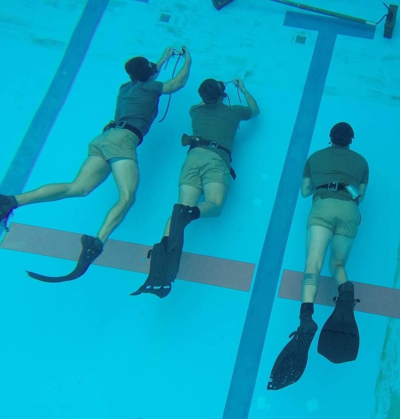 Reconnaissance Marines finish the 25 meter swim on the bottom of a 13-foot pool to practice breathe holding techniques Nov. 18 during a pre-combatant diver course at Camp Schwab. After The Marines swam 25 meters underwater, they tied a rope around a pole and then swam 25 meters back underwater. This technique teaches the Marines how to control themselves and stay calm while completing a task underwater. When the Marines complete the pre-combatant diver course, they will attend the Combatant Divers Course. The Marine Corps Combatant Diver Course provides underwater tactical training and skills needed to successfully conduct underwater navigation for infiltration and exfiltration in hostile environments. The Marines are from 3rd Reconnaissance Battalion, 3rd Marine Division, III Marine Expeditionary Force. 