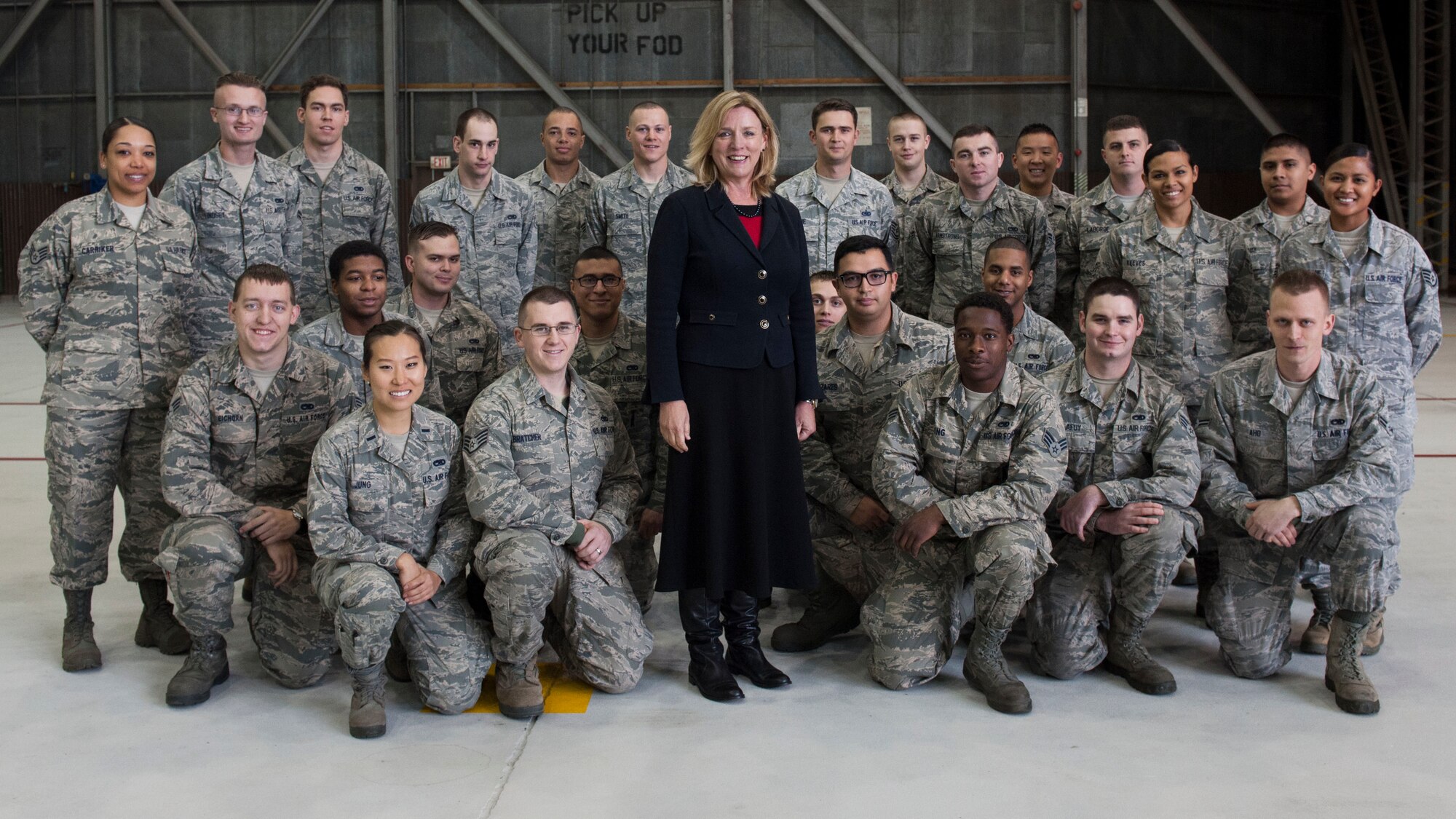 Secretary of the Air Force Deborah Lee James poses with 8th Aircraft Maintenance Squadron Airmen during her first tour of Kunsan Air Base, Republic of Korea, Nov. 22, 2014. James spent time at Kunsan as part of her visit to Pacific Command bases to meet with Airmen and understand their mission. (U.S. Air Force photo by Senior Airman Katrina Heikkinen/Released) 