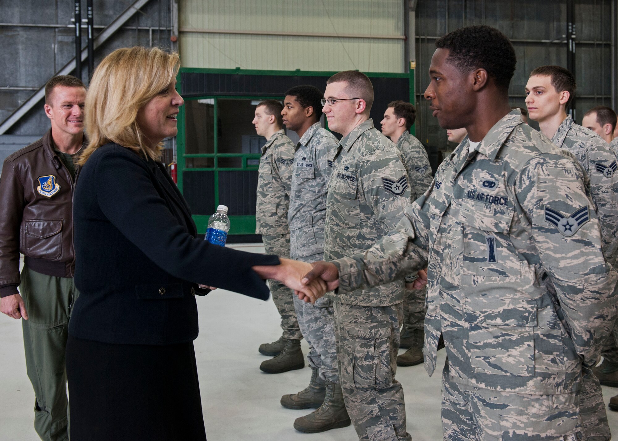 Secretary of the Air Force Deborah Lee James talks to Senior Airman Shaun King, 8th Aircraft Maintenance Squadron airfield mechanic, as part of her visit to Kunsan Air Base, Republic of Korea, Nov. 22, 2014. During James’ first visit to Kunsan, she took time to meet, recognize and answer the questions of Wolf Pack Airmen, as well as stress her top three priorities. (U.S. Air Force photo by Senior Airman Katrina Heikkinen/Released)