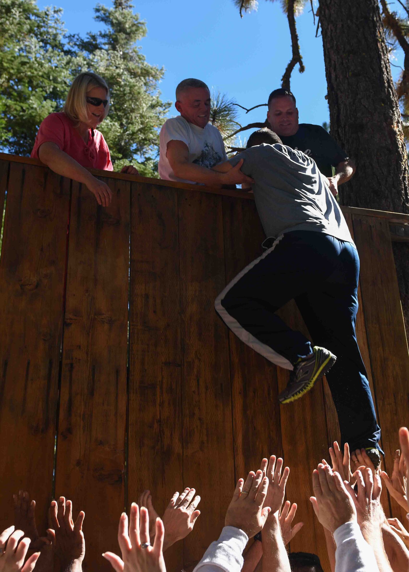 A team building exercise involving 940th Wing leaders of all ranks work together to help members climb a wall at a Leadership Summit in Tahoe, Calif., Oct. 6, 2014. The gathering included presentations on current pay, travel, and mentoring programs along with team building exercises. (U.S. Air Force photo by Staff Sgt. Brenda Davis/Released)