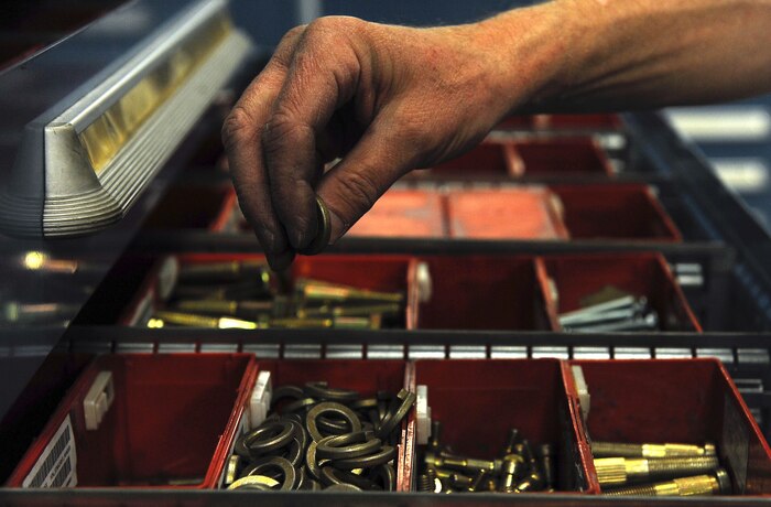 Guy Greene, a contractor with the 57th Maintenance Group, sorts parts into their corresponding drawer at the Aerospace Ground Equipment hangar on Nellis Air Force Base, Nev., Nov. 20, 2014. Greene, is in charge of holding those who check out tools responsible for returning them, ensuring they do not become foreign object debris on the flightline.  (U.S. Air Force photo by Airman 1st Class Rachel Loftis)  