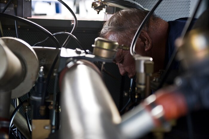Joe LeonGuerreo, a contractor with the 57th Maintenance Group, works on a C-10 air conditioner at the Aerospace Ground Equipment hangar on Nellis Air Force Base, Nev., Nov. 20, 2014. AGE workers repair flightline support equipment by studying drawings, wiring diagrams and schematics, and technical publications. (U.S. Air Force photo by Airman 1st Class Mikaley Towle) 