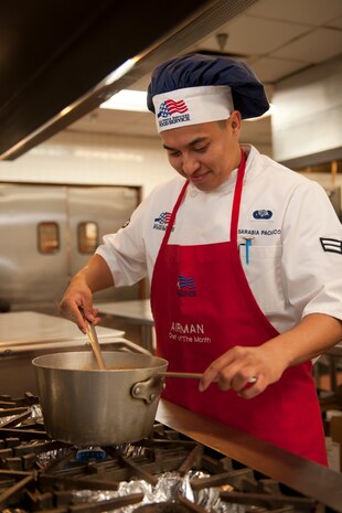 Airman 1st Class Saul Sarabia Pacheco, 99th Force Support Squadron food service apprentice, prepares a soup at the Crosswinds Inn Dining Facility, Nellis Air Force Base, Nev., Nov. 24, 2014.  The FSS is scheduled to host a Thanksgiving meal, open to all Department of Defense ID cardholders, at the Crosswinds, Nov. 27 from 11 a.m. to 1 p.m. The meal will be served by senior leadership from across the base.  The meal includes roasted turkey and beef, baked ham, mashed potatoes, corn bread dressing, macaroni and cheese, and a variety of desserts.  The cost for the meal is $8 per plate and a shrimp cocktail may be added for an additional $5. For additional information contact the dining facility at 702.652.6741.   (U.S. Air Force photo by Staff Sgt. Victoria Sneed)