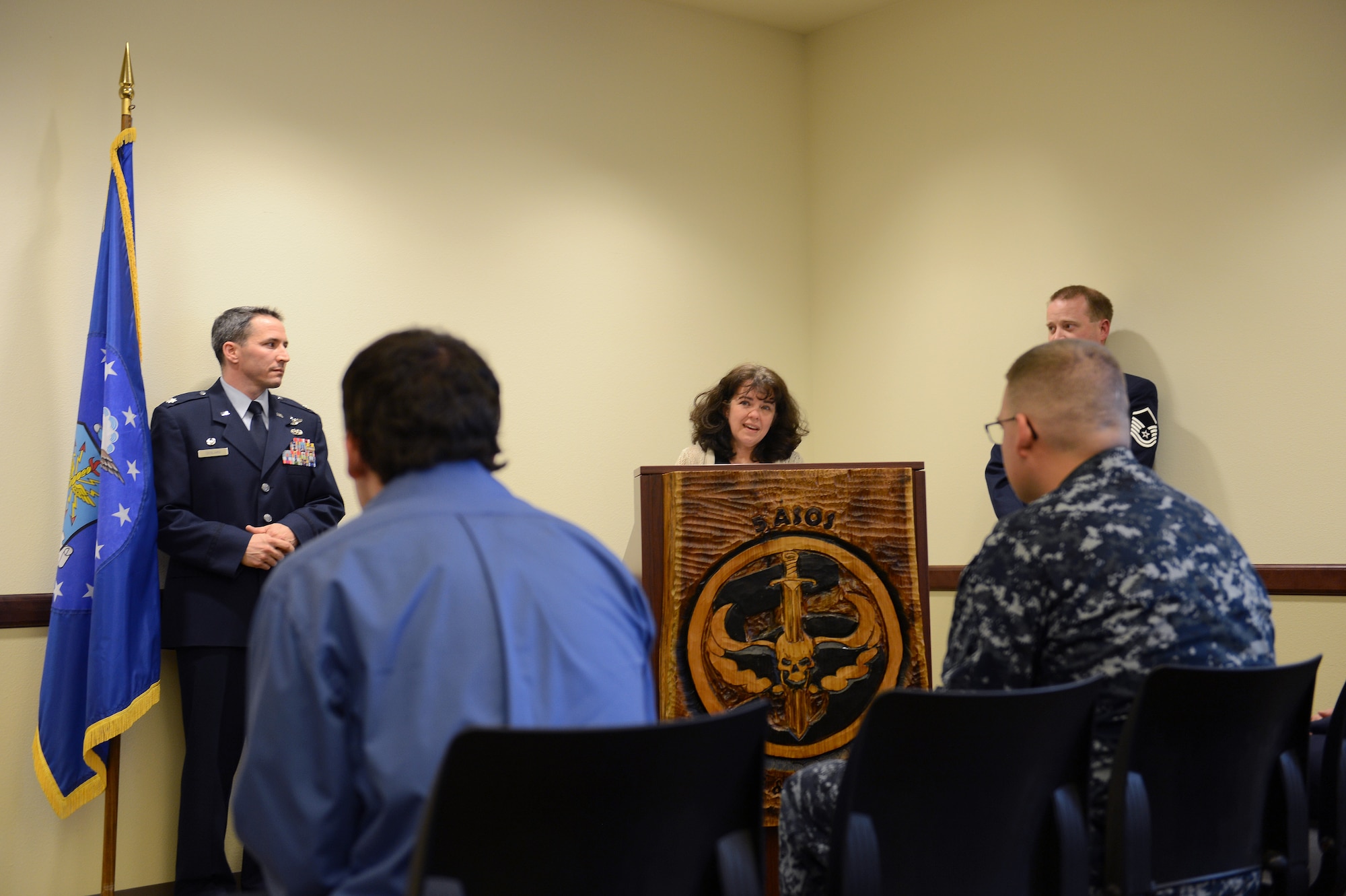 Jennifer Auchman (middle), wife of Master Sgt. Steven Auchman, shares a few words with the members of the 5th Air Support Operations Squadron Nov. 21, 2014, during the Auchman Auditorium Dedication Ceremony at Joint Base Lewis-McChord, Wash. The ceremony was given 10 years after Master Sgt. Steven Auchman was killed from the injuries sustained during a mortar attack in Mosul, Iraq. (U.S. Air Force photo/Airman 1st Class Keoni Chavarria)