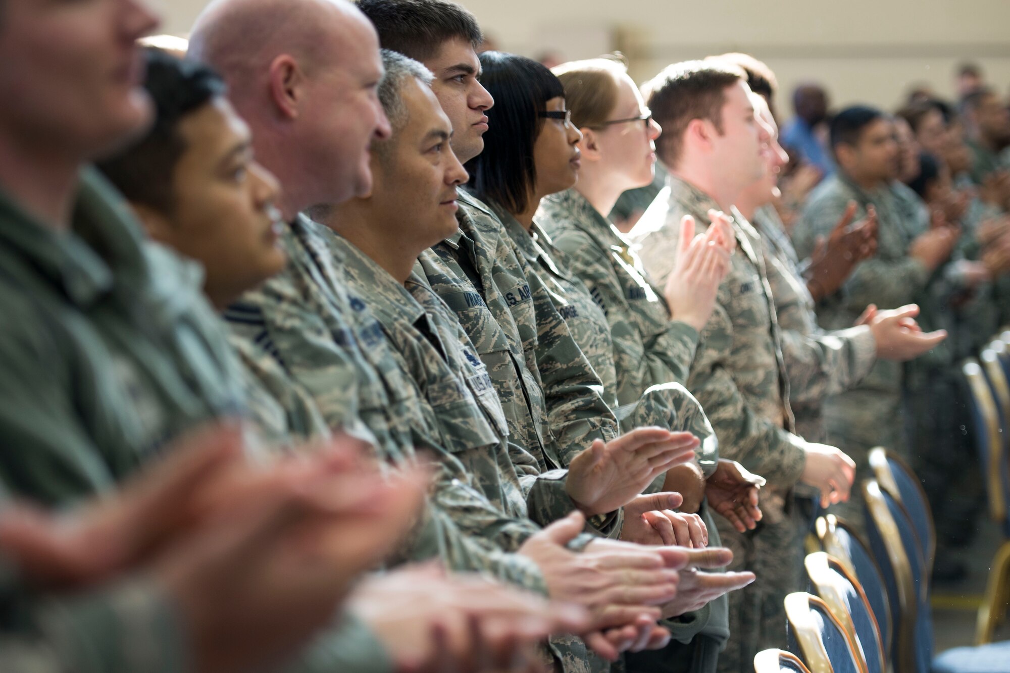 The crowd claps for a fellow Airmen as he is recognized by Secretary of the Air Force Deborah Lee James during an all call at Yokota Air Base, Japan, Nov. 21, 2014. James mentioned the importance of her main priority – taking care of Airmen – during the all call and thanked the service members for their commitment to the mission. (U.S. Air Force photo by Staff Sgt. Cody H. Ramirez/Released)