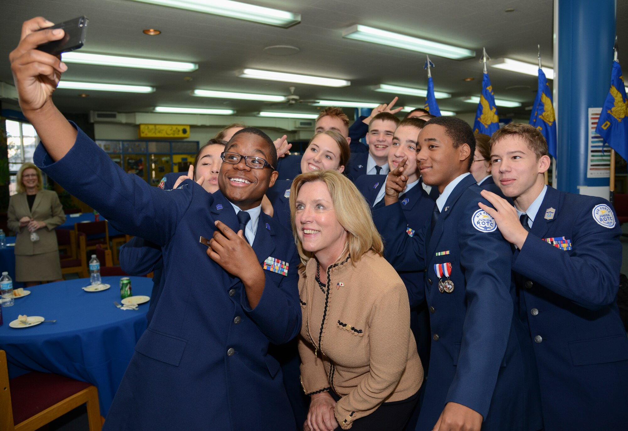 Secretary of the Air Force Deborah Lee James takes a selfie with Junior ROTC Cadets at Yokota’s High School at Yokota Air Base, Japan, Nov. 21, 2014. Along with having lunch and getting to know the cadets, James participated in a question and answer session. Secretary James visited Yokota to discuss the future of the Air Force and as well as meet Airmen serving in the region. (U.S. Air Force photo by Senior Airman Michael Washburn/Released)