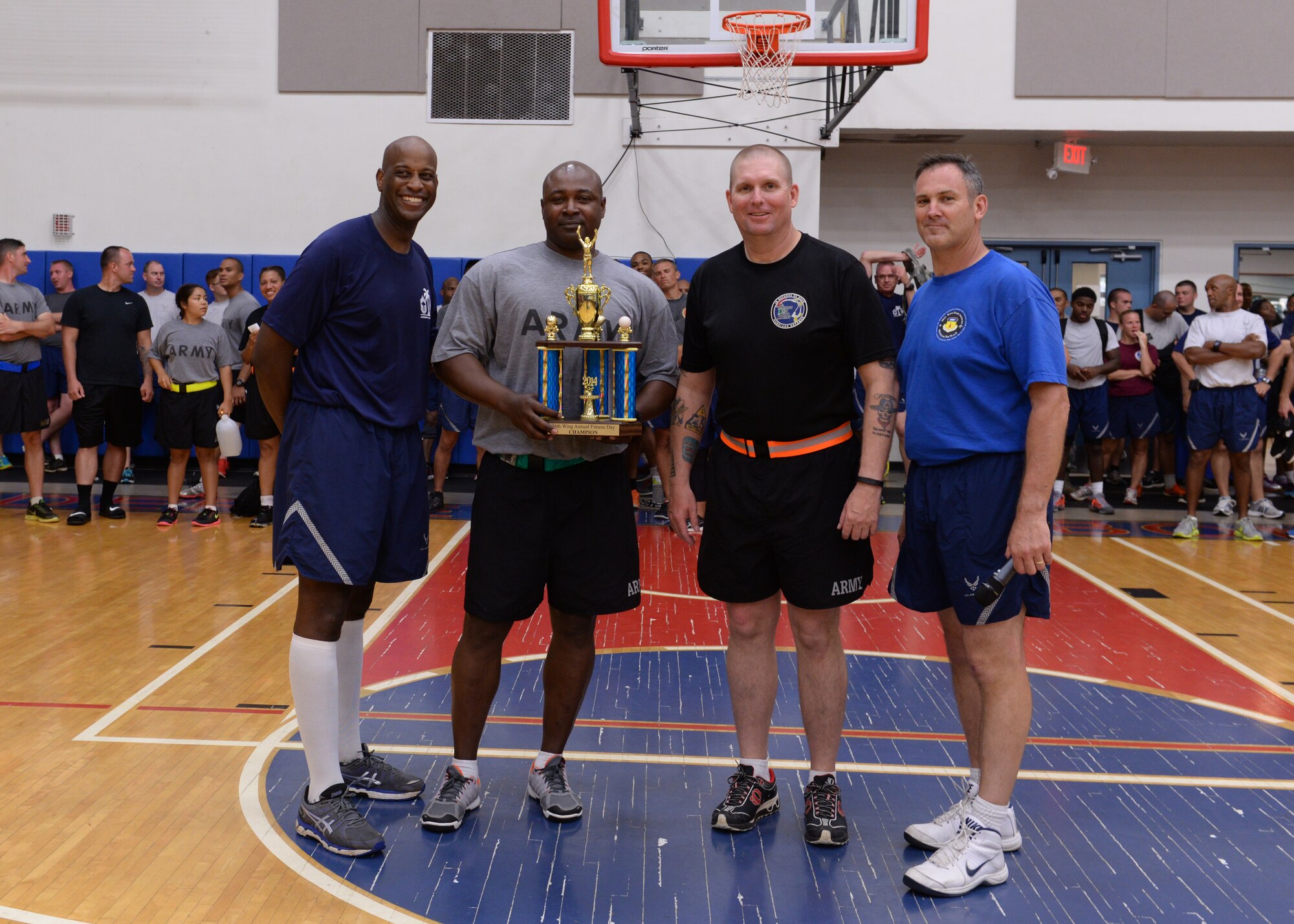 Brig Gen. Andrew Toth, 36th Wing commander and Chief Master Sgt. Michael McMillan, 36th Wing command chief, pose with Lt. Col. Clyde Cochrane, Task Force Talon commander and  Sgt. Maj. Johnny Woodley, Task Force Talon command sergeant major, during the trophy ceremony during Resiliency Day Nov. 21, 2014, on Andersen Air Force Base, Guam. The Task Force Talon unit won the most games during resiliency day earning them first place overall. (U.S. Air Force photo by Senior Airman Cierra Presentado/Released)