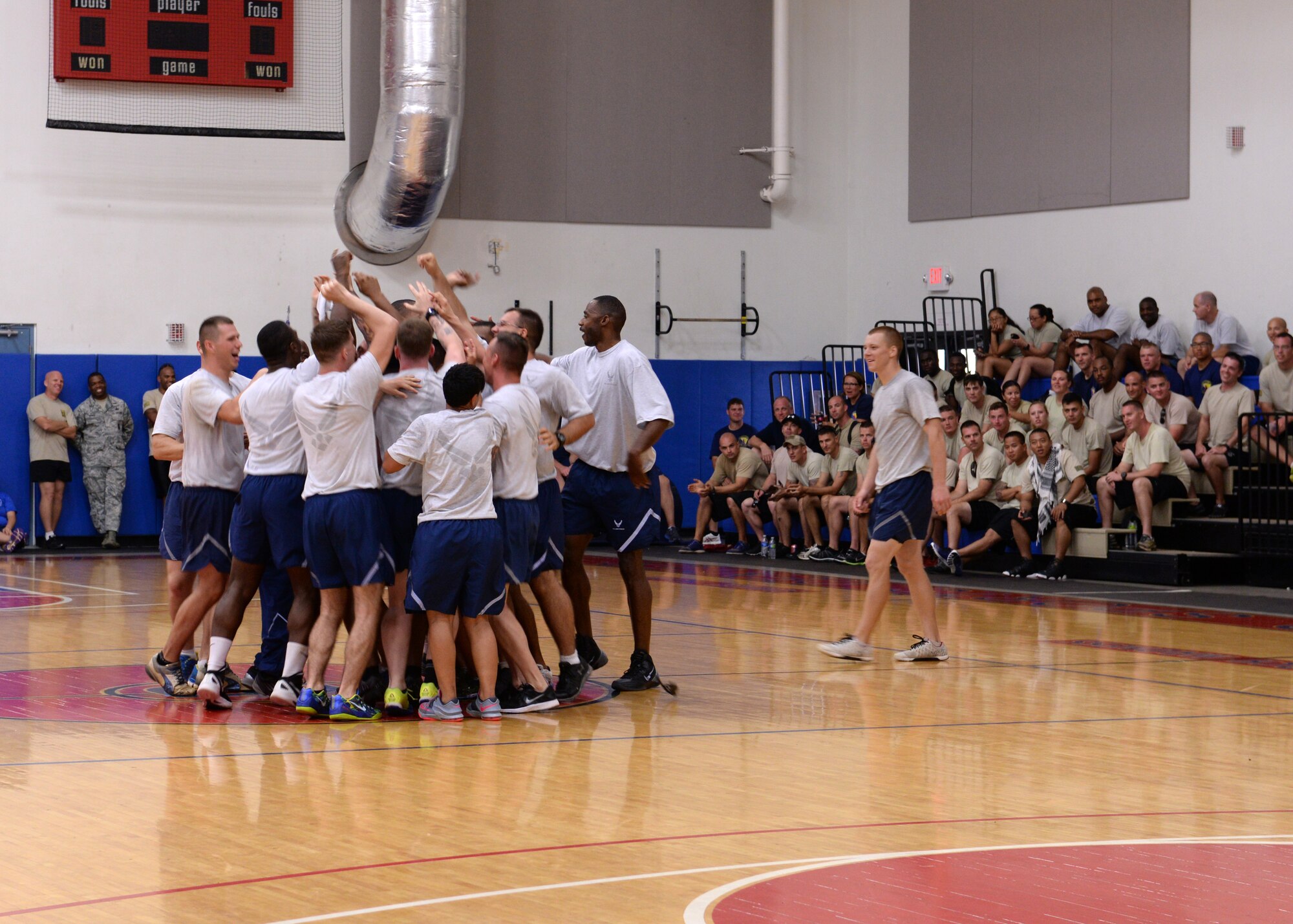 The 36th Security Forces Squadron cheers after winning the final championship basketball game during Resiliency Day Nov. 21, 2014, on Andersen Air Force Base, Guam. Resiliency Day was designed to give Airmen a chance to experience wingmanship and resiliency through training and team building sports. (U.S. Air Force photo by Senior Airman Cierra Presentado/Released)