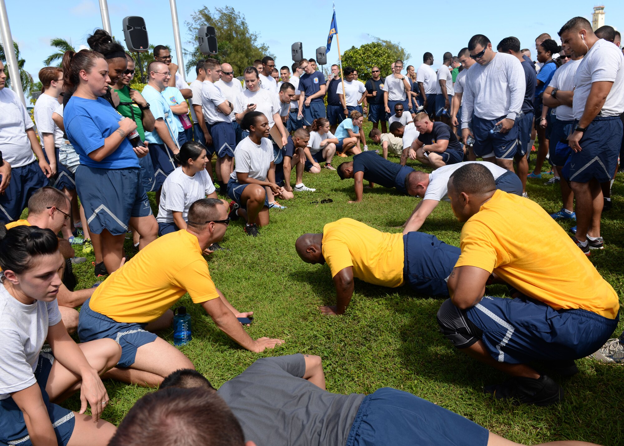 Members of Team Andersen participate in a push-up competition during Resiliency Day Nov. 21, 2014, on Andersen Air Force Base, Guam. Squadrons throughout the base participated in games and events as part of a base wide stand down to focus on resilience training and wingmanship. (U.S. Air Force photo by Senior Airman Cierra Presentado/Released)